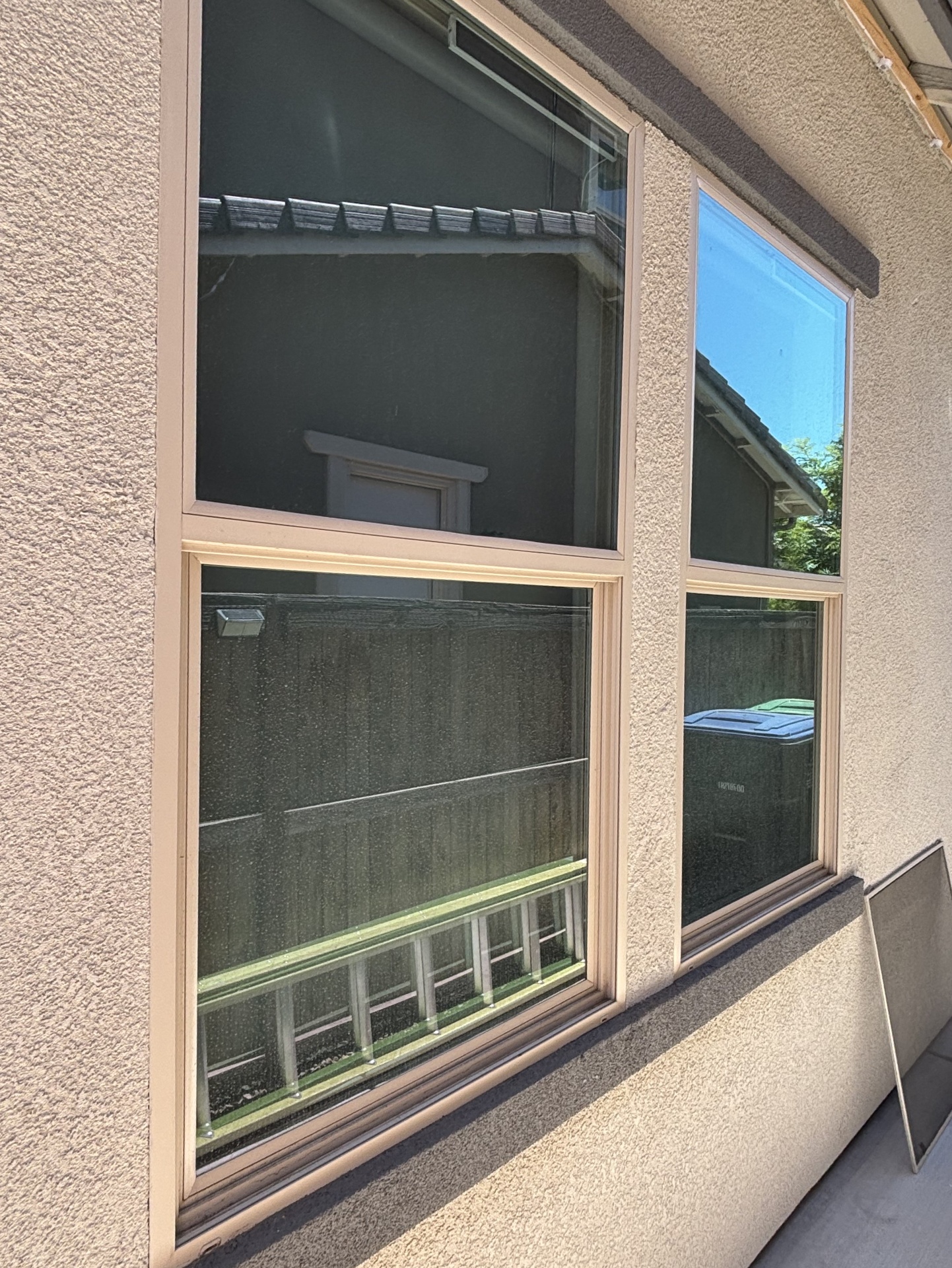 Dirty window before cleaning showing water spots, streaks, and grime buildup